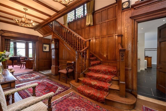 The reception hall is one of the highlights of the house, characterised by its original oak panelling, broad oak staircase and carved door facings.