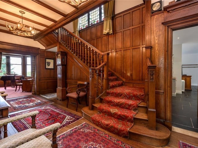 The reception hall is one of the highlights of the house, characterised by its original oak panelling, broad oak staircase and carved door facings.
