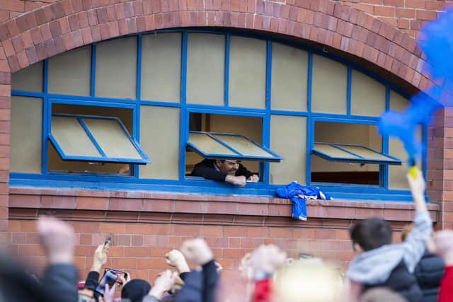 GLASGOW, SCOTLAND - MARCH 06: Rangers manager Steven Gerrard celebrates out the dressing room window with fans outside during a Scottish Premiership match between Rangers and St Mirren at Ibrox Stadium, on March 06, 2021, in Glasgow, Scotland.