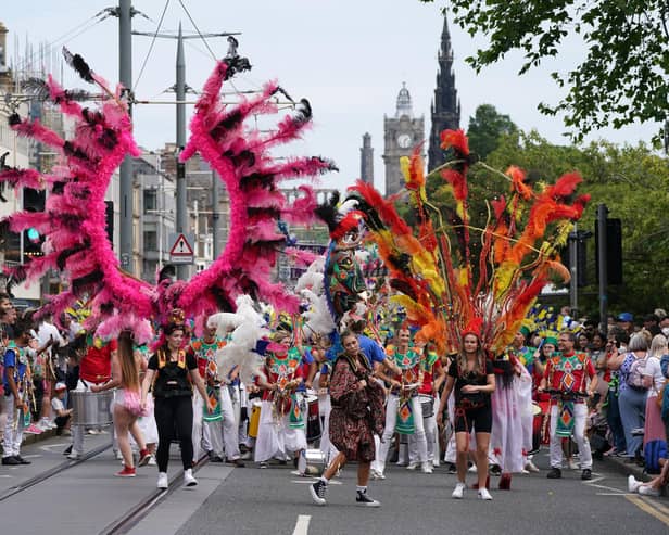 Performers from at least 13 countries paraded along Princes Street during the Edinburgh Festival Carnival (Picture: Andrew Milligan/PA)