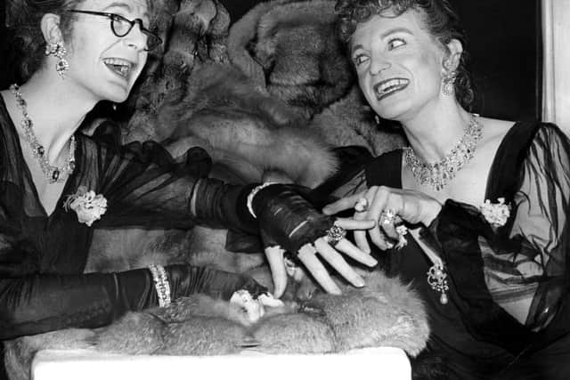 Hinge and Bracket - George Logan, left, and Patrick Fyffe - select furs and jewellery before performing for Princess Anne in 1975  (Photo by David Ashdown/Keystone/Getty Images)