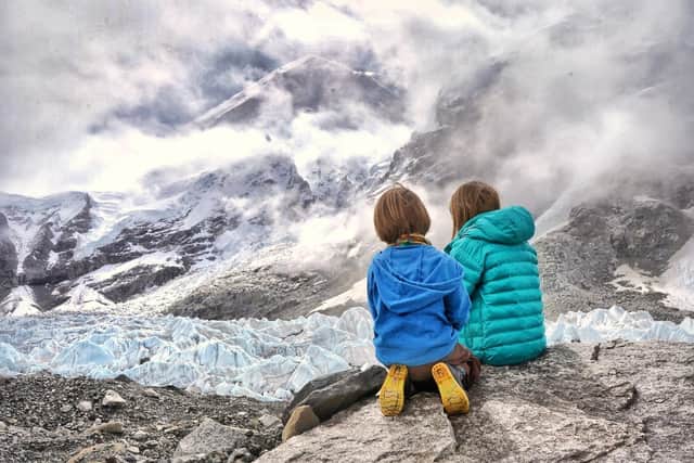 Four-year-old Jacob and nine-year-old Erihn look over the mountains