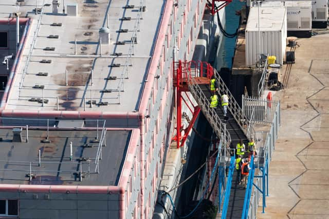 Workers at the Bibby Stockholm accommodation barge at Portland Port in Dorset, which will house up to 500 people.