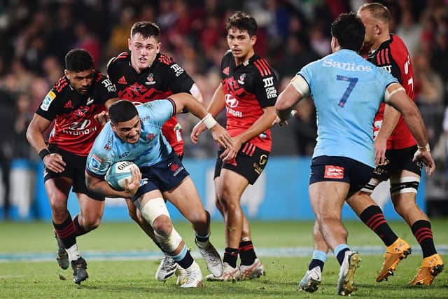 Mosese Tuipulotu, with ball in hand, playing for the Waratahs against the Crusaders in a Super Rugby Pacific match at Orangetheory Stadium in Christchurch. (Photo by Sanka Vidanagama / AFP via Getty Images)