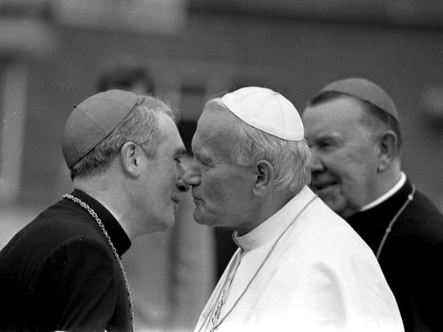 Pope John Paul II is greeted by Archbishop Thomas Winning (later Cardinal Winning) when he lands at Turnhouse Airport. Cardinal Winning had played a major role in ensuring the Papal visit went ahead.