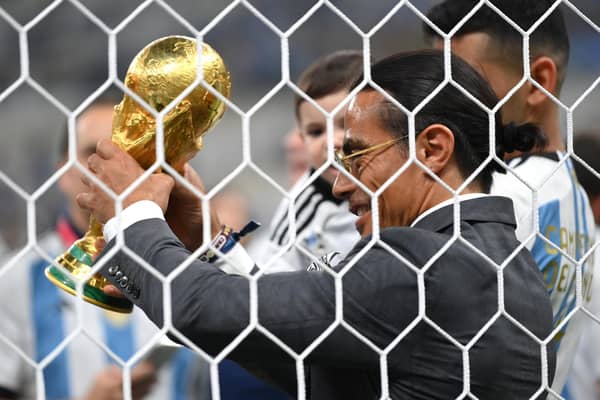 Nusret Goekce, nicknamed Salt Bae, gets his hands on the World Cup trophy last year in Qatar.