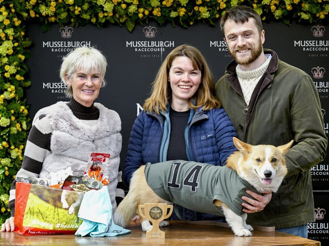 Winner of the Corgi Derby, Juno with his owners Fran Brandon and Alisdair Tew, is presented a trophy from Judy Murray at Musselburgh Racecourse