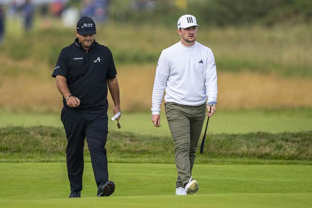 Connor Syme walks with Patrick Reed during first round at Royal Liverpool. Picture: Tom Russo/The Scotsman.