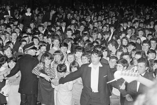 Police and officials stuggle to hold back teenagers at the Mod Ball in the Waverley Market in Edinburgh. Concert-goers stormed the stage when "The Pretty Things" were playing after it was announced that "The Animals" would not be appearing.