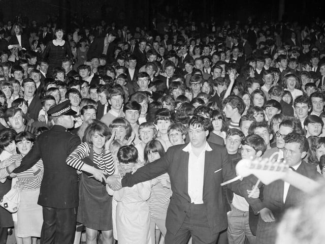 Police and officials stuggle to hold back teenagers at the Mod Ball in the Waverley Market in Edinburgh. Concert-goers stormed the stage when "The Pretty Things" were playing after it was announced that "The Animals" would not be appearing.