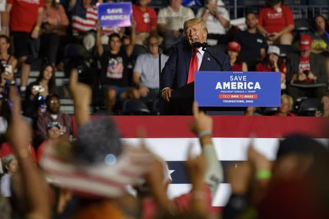 Supporters raise their right arm and finger as Donald Trump speaks at a Save America Rally to support Republican candidates running for office in Ohio (Picture: Jeff Swensen/Getty Images)