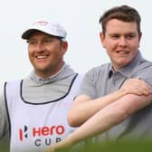 Bob MacIntyre shares a joke with his caddie, Mike Thomson, during the Hero Cup at Abu Dhabi Golf Club. Picture: Andrew Redington/Getty Images.