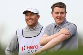 Bob MacIntyre shares a joke with his caddie, Mike Thomson, during the Hero Cup at Abu Dhabi Golf Club. Picture: Andrew Redington/Getty Images.