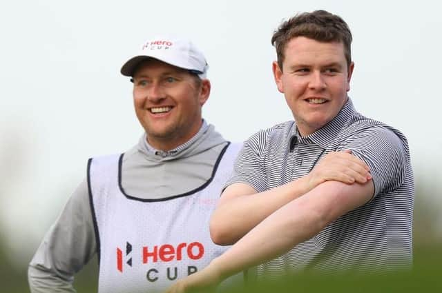 Bob MacIntyre shares a joke with his caddie, Mike Thomson, during the Hero Cup at Abu Dhabi Golf Club. Picture: Andrew Redington/Getty Images.