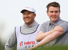 Bob MacIntyre shares a joke with his caddie, Mike Thomson, during the Hero Cup at Abu Dhabi Golf Club. Picture: Andrew Redington/Getty Images.