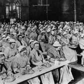 Women have dinner at a workhouse in London in around 1900 (Picture: General Photographic Agency/Getty Images)