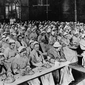 Women have dinner at a workhouse in London in around 1900 (Picture: General Photographic Agency/Getty Images)