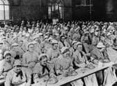 Women have dinner at a workhouse in London in around 1900 (Picture: General Photographic Agency/Getty Images)