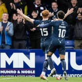 Ross County's Simon Murray (L) celebrates with Yan Dhanda and Josh Sims during the win against Rangers.