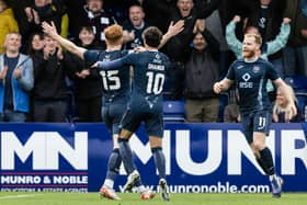 Ross County's Simon Murray (L) celebrates with Yan Dhanda and Josh Sims during the win against Rangers.