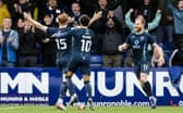 Ross County's Simon Murray (L) celebrates with Yan Dhanda and Josh Sims during the win against Rangers.