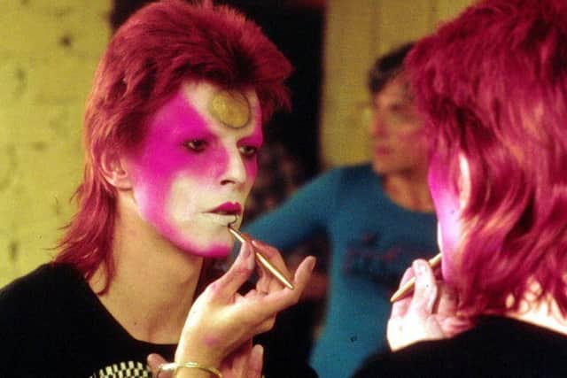 David Bowie applying his Ziggy Stardust makeup in the 1970s. (Picture: R Bamber/Rex Features)