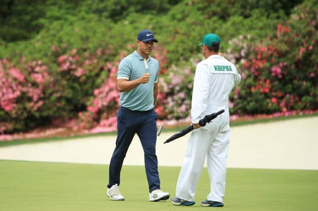Brooks Koepka reacts to his eagle on the 13th green with caddie Ricky Elliott during the final round of the 2019 Masters at Augusta National. Picture: Andrew Redington/Getty Images