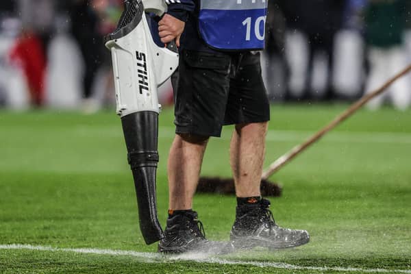 Staff at Hampden Park work on the waterlogged pitch during Scotland's Euro 2024 qualifying win over Georgia. (Photo by Craig Foy / SNS Group)