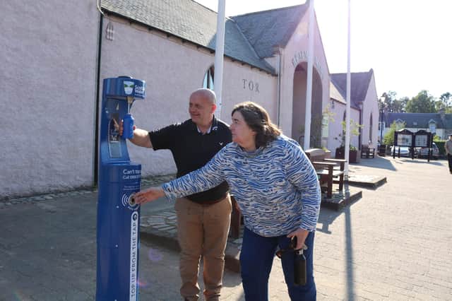 Councillor Blackett with a Braemar tour guide at the village's new Top up Tap.