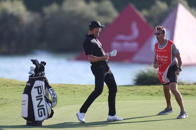 AVictor Perez and his caddie James Erkenbeck celebrate after the Frenchman holed out from a bunker at the 17th in the final round. Picture: Oisin Keniry/Getty Images.