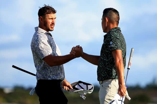 Brooks Koepka, left, and Collin Morikawa shake hands during the final round of the 2021 Hero World Challenge at Albany Golf Course in Nassau. Picture: Mike Ehrmann/Getty Images.