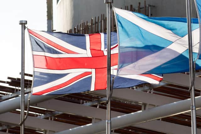 The Union flag and the Saltire fly outside the Scottish Parliament