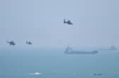 Chinese military helicopters fly past Pingtan island ahead of massive military drills off Taiwan (Picture: Hector Retamal/AFP via Getty Images)