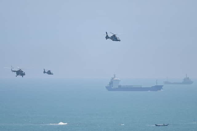 Chinese military helicopters fly past Pingtan island ahead of massive military drills off Taiwan (Picture: Hector Retamal/AFP via Getty Images)