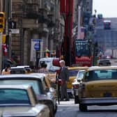 A body double for Harrison Ford on Cochrane Street in Glasgow city centre during filming the new Indiana Jones 5 movie starring Harrison Ford in July 2021.