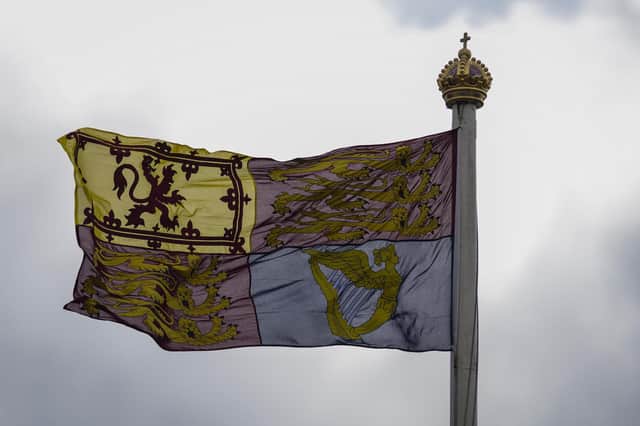 The Royal Standard of the United Kingdom flies at Buckingham Palace as King Charles III and Camilla, Queen Consort arrive for residence