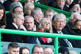 Former Celtic chief executive Peter Lawwell (right) watches a match at Celtic Park with his son Mark (left).