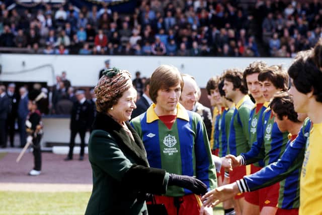 Kenny Dalglish introduces Queen Elizabeth II to members of the Glasgow Select XI before the match against a Football League XI at Hampden Park. The match was in aid of the Silver Jubilee Appeal.