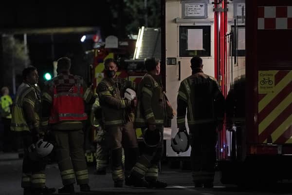 Firefighters at the scene in Sutton, south London, where four children have died following a fire at a house.