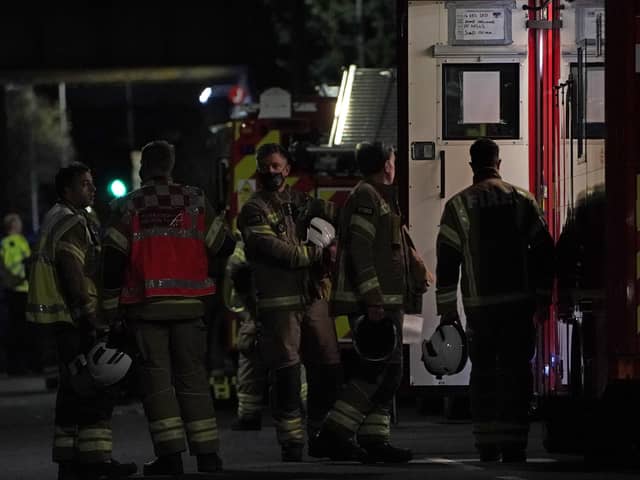 Firefighters at the scene in Sutton, south London, where four children have died following a fire at a house.