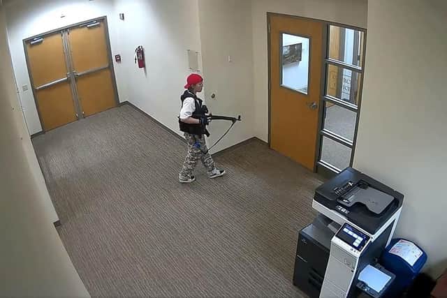 Suspect Audrey Hale holding an assault rifle at the Covenant School building at the Covenant Presbyterian Church, in Nashville, Tennessee. - A heavily armed former student killed three young children and three staff in what appeared to be a carefully planned attack at a private elementary school in Nashville on Monday, before being shot dead by police. Photo by -/Metropolitan Nashville Police De/AFP via Getty Images