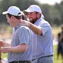 Shane Lowry congratulates Bob MacIntyre after one of his wins for Great Britain and Ireland in the inaugural Hero Cup in Abu Dhabi. Picture: Ross Kinnaird/Getty Images.