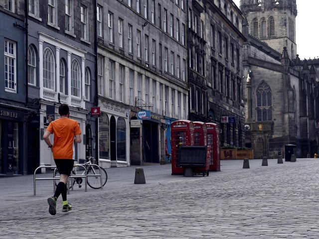 A runner takes his one allotted exercise on the Royal Mile, Edinburgh (Picture: Lisa Ferguson)