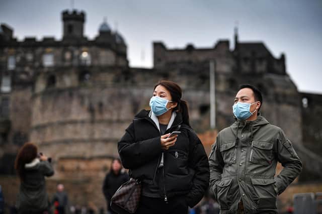 Tourists wear face masks as they visit Edinburgh Castle