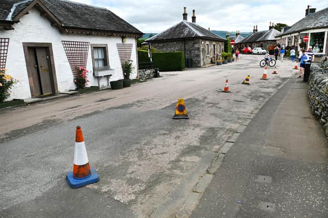 Cones have been put down by residents to block visitors from parking in the centre of the village. PIC: John Devlin