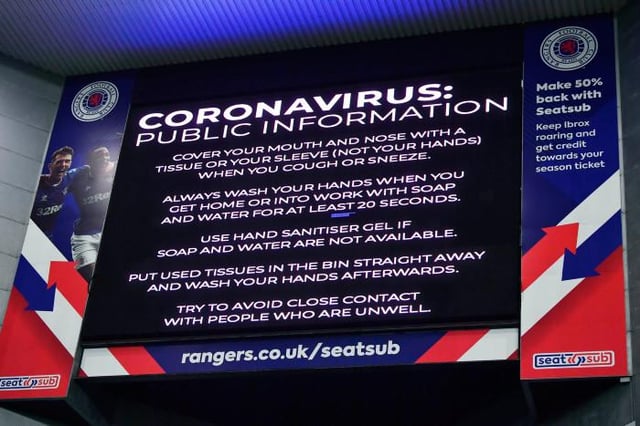Coronavirus warning notices were prevalent last March - as seen here displayed on the big screens at Ibrox, days before the game was shutdown (Photo by Rob Casey / SNS Group)