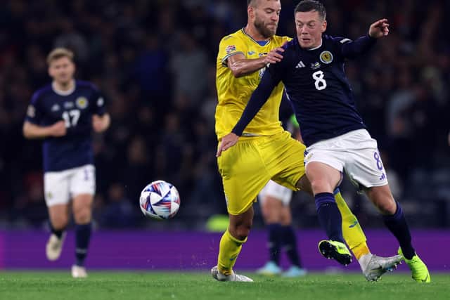 Andriy Yarmolenko of Ukraine and Callum McGregor of Scotland tussle for possession during Wednesday's match at Hampden.