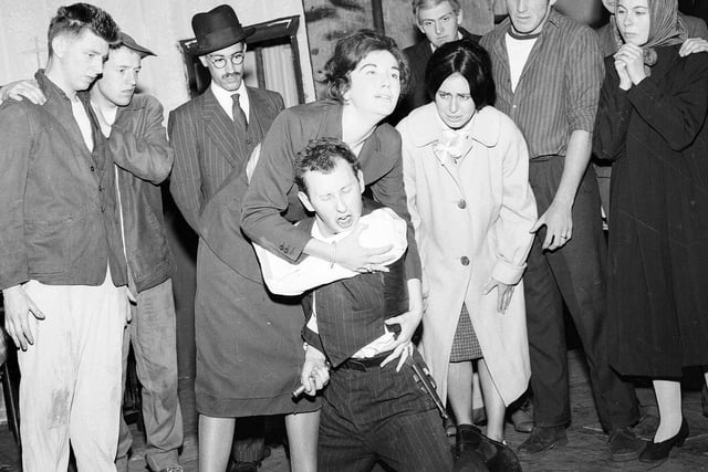 Members of the 60 Group rehearsing Arthur Miller's 'A View from the Bridge', one of their Edinburgh Festival Fringe shows,  in 1963. The man being held at front is Michael Cronin, best known for playing Mr 'Bullet' Baxter in Grange Hill.