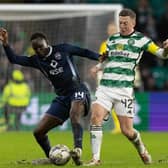 Celtic's Callum McGregor and Ross County's Victor Loturi in action.