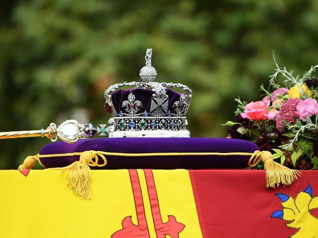 LONDON, ENGLAND - SEPTEMBER 19: The coffin of Queen Elizabeth II with the Imperial State Crown resting on top is carried by the Bearer Party as it departs Westminster Abbey during the State Funeral of Queen Elizabeth II on September 19, 2022 in London, England. Elizabeth Alexandra Mary Windsor was born in Bruton Street, Mayfair, London on 21 April 1926. She married Prince Philip in 1947 and ascended the throne of the United Kingdom and Commonwealth on 6 February 1952 after the death of her Father, King George VI. Queen Elizabeth II died at Balmoral Castle in Scotland on September 8, 2022, and is succeeded by her eldest son, King Charles III.  (Photo by Joe Maher/Getty Images)